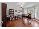 Well-lit office space with hardwood floors, bookcases, and a traditional-style desk, chair, and overhead lighting at 806 Mcgregor Ne Dr, Concord, NC 28025