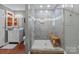 Bathroom showing tiled shower with glass door and built-in bench seating at 806 Mcgregor Ne Dr, Concord, NC 28025