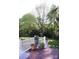 Charming back deck with white railing, potted plants and scenic views of the backyard and mature shade trees at 854 Silver Fox Dr, Concord, NC 28025