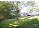 Large backyard with trees and lush green grass offers ample space for outdoor activities and entertaining at 854 Silver Fox Dr, Concord, NC 28025