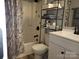 The cozy bathroom features a shower with marble curtain, white vanity and neutral-tone tile flooring at 854 Silver Fox Dr, Concord, NC 28025
