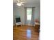 This bright bedroom offers hardwood floors, window with curtains and ample natural light, and small black board at 854 Silver Fox Dr, Concord, NC 28025