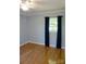 This sunny bedroom features hardwood floors, closet, window with curtains and ample natural light at 854 Silver Fox Dr, Concord, NC 28025