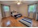 Inviting bedroom featuring hardwood floors, complemented by natural light from two windows and a cozy rug at 854 Silver Fox Dr, Concord, NC 28025