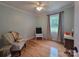 Charming bedroom featuring hardwood floors, soft-toned walls, and a window offering serene views; accented by playful decor at 854 Silver Fox Dr, Concord, NC 28025