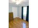 This bright bedroom offers hardwood floors, closet, window with curtains and ample natural light at 854 Silver Fox Dr, Concord, NC 28025