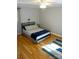 This well-lit bedroom offers hardwood floors, a ceiling fan, and a metal-framed bed at 854 Silver Fox Dr, Concord, NC 28025