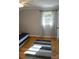 Featuring hardwood floors, a ceiling fan, and a bright window, this bedroom offers ample natural light at 854 Silver Fox Dr, Concord, NC 28025