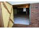 View of the crawlspace entry featuring sealed walls, a vapor barrier, and protected brick foundation at 854 Silver Fox Dr, Concord, NC 28025