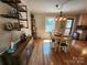 Cozy dining room with a wooden table, four chairs, and a stylish industrial light fixture at 854 Silver Fox Dr, Concord, NC 28025