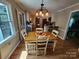 Well-lit dining area featuring hardwood floors, a wooden table, and a view to the kitchen at 854 Silver Fox Dr, Concord, NC 28025