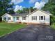Charming home with a bright blue door, a cozy porch, and a spacious driveway at 854 Silver Fox Dr, Concord, NC 28025