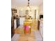 Bright and airy kitchen showcasing a functional island, hardwood floors, and seamless access to the dining area at 854 Silver Fox Dr, Concord, NC 28025