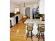 Bright kitchen featuring granite countertops, white cabinetry, hardwood floors, and a functional kitchen island at 854 Silver Fox Dr, Concord, NC 28025