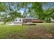 Large backyard with concrete patio, lush lawn, and mature trees at 101 Wynnchester Rd, Gastonia, NC 28056