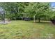 Lush backyard featuring a trampoline, basketball court, and ample shade trees at 101 Wynnchester Rd, Gastonia, NC 28056