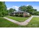 A charming home with lush lawn and landscaping; a sidewalk wraps around the front and side of the house at 101 Wynnchester Rd, Gastonia, NC 28056