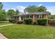 Beautiful brick home with black shutters, lush green lawn, and manicured landscaping at 101 Wynnchester Rd, Gastonia, NC 28056