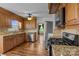 Well-equipped kitchen with stainless steel appliances, granite countertops, and wooden cabinetry at 101 Wynnchester Rd, Gastonia, NC 28056