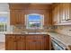 Kitchen close up featuring granite countertops, tile backsplash, wooden cabinets, and stainless steel appliances at 101 Wynnchester Rd, Gastonia, NC 28056