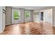 Open living room featuring hardwood floors, large windows, and an open door at 101 Wynnchester Rd, Gastonia, NC 28056
