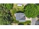 Overhead view of a gray roof house with a deck, grill, fire pit, manicured lawn and mature trees at 1011 Master Gunner Ct, Indian Trail, NC 28079