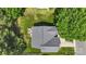 An aerial view of a well maintained home featuring a gray roof, manicured lawn, and mature trees at 1011 Master Gunner Ct, Indian Trail, NC 28079