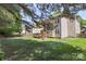Expansive backyard with a lush lawn, deck, and mature trees offering shade at 1011 Master Gunner Ct, Indian Trail, NC 28079