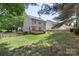 Spacious backyard with a well-maintained lawn, deck, and charming picket fence at 1011 Master Gunner Ct, Indian Trail, NC 28079
