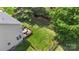 Aerial view of a backyard featuring a deck with furniture, a grill, a fire pit, and a fenced lawn at 1011 Master Gunner Ct, Indian Trail, NC 28079