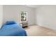 Comfortable bedroom with a twin bed, side table, and large window at 1011 Master Gunner Ct, Indian Trail, NC 28079