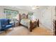 Comfortable bedroom with an ornate four-poster bed and plenty of natural light at 1011 Master Gunner Ct, Indian Trail, NC 28079