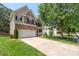 Charming two-story home with a brick and siding exterior, well-manicured lawn, and attached two car garage at 1011 Master Gunner Ct, Indian Trail, NC 28079