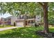 Inviting two-story brick and siding home with a well maintained lawn, attached garage, and mature trees at 1011 Master Gunner Ct, Indian Trail, NC 28079