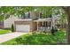 Charming two-story home featuring a brick facade, attached garage, and covered front porch at 1011 Master Gunner Ct, Indian Trail, NC 28079