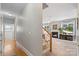 Hallway leads to the living room with fireplace and the wooden stairway to the second level at 1011 Master Gunner Ct, Indian Trail, NC 28079