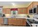 Bright kitchen featuring stainless appliances, wood cabinets and light countertops at 1011 Master Gunner Ct, Indian Trail, NC 28079