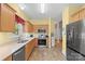 Well-lit kitchen showcases stainless appliances, light countertops and ample wood cabinets at 1011 Master Gunner Ct, Indian Trail, NC 28079