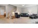 Open living room showcasing staircase, neutral colors and comfortable furniture at 1011 Master Gunner Ct, Indian Trail, NC 28079
