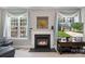 Inviting living room features a fireplace, large windows, and cozy seating at 1011 Master Gunner Ct, Indian Trail, NC 28079
