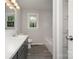 Bright bathroom with a tub, white countertop, and gray shaker cabinets at 102 Erwin St, Chester, SC 29706