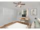 Cozy bedroom with a ceiling fan, hardwood floors, and a desk against the wall at 102 Erwin St, Chester, SC 29706