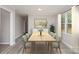Bright dining room with a long wooden table and seating for six under a modern fixture at 102 Erwin St, Chester, SC 29706