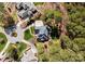 Aerial view showcasing the house, landscaped backyard, and mature trees in a residential neighborhood at 107 Waterhouse Ct, Mooresville, NC 28117