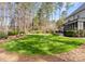 Lush backyard with a well-manicured lawn, mature trees, and an inviting space for outdoor activities at 107 Waterhouse Ct, Mooresville, NC 28117