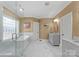 Elegant bathroom with a soaking tub, glass shower, and marble countertop vanity at 107 Waterhouse Ct, Mooresville, NC 28117
