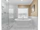 Bright bathroom features a walk-in shower and free-standing soaking tub at 107 Waterhouse Ct, Mooresville, NC 28117