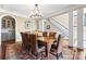 Dining area featuring hardwood floors, an ornate chandelier, and a large dining table with chairs at 107 Waterhouse Ct, Mooresville, NC 28117