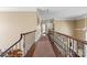 Spacious upstairs hallway with iron railings and hardwood floors at 107 Waterhouse Ct, Mooresville, NC 28117