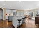 Kitchen featuring stainless steel appliances, an island with seating, and views to the living area at 107 Waterhouse Ct, Mooresville, NC 28117